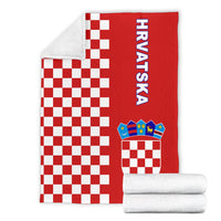 Folded red checkerboard half-style blanket with “Hrvatska” text and crest