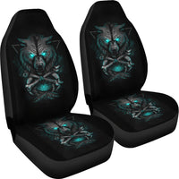 Set of black car seat covers with teal glowing wolf and crossed swords design