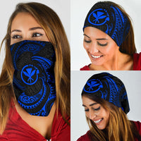 Blue tribal wave bandana with black swirls and sun-like emblem, worn over face