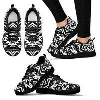 Black-and-white tribal sneakers, side view with black laces and black sole