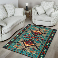 Geometric tribal area rug with teal border, tan shapes, and orange diamond center