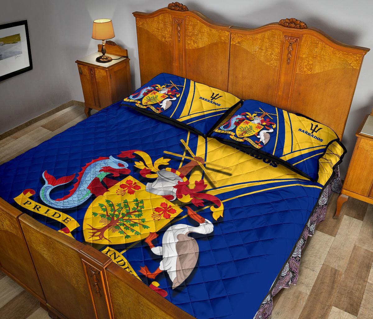 Barbados bed set with blue quilt, yellow flag stripe center, coat of arms and two pillows