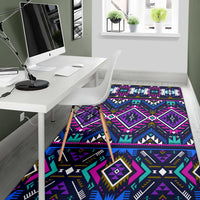 Colorful geometric area rug in purple, blue, and teal with repeating diamond pattern