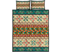 Folded multicolor Native border quilt layout: diamonds, stripes, dots, and teal trim