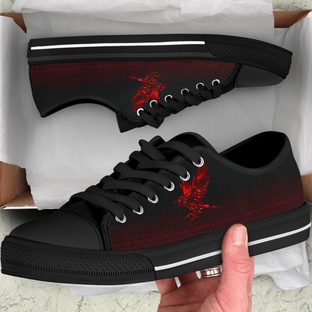Black low-top sneakers with red rune graphic and black laces, white trim sole stripe