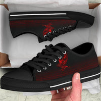 Black low-top sneakers with red rune graphic and black laces, white trim sole stripe