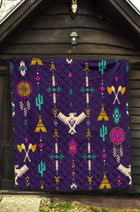 Blue quilt with multicolor Native geometric thunderbird design, quilted diamond texture