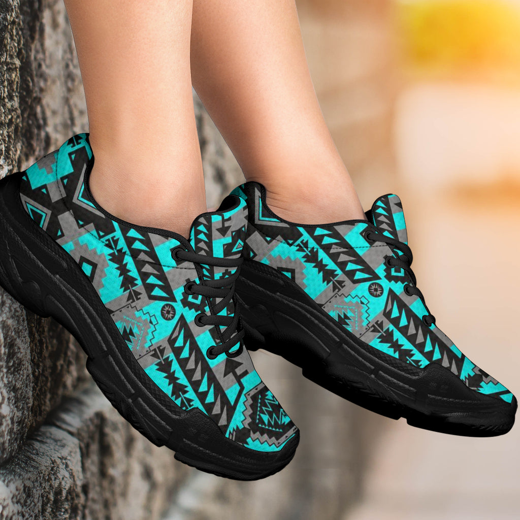 Chunky sneakers close-up, turquoise tribal pattern with black laces and thick black sole