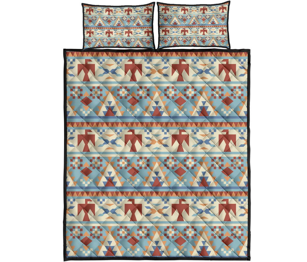 Light blue quilt bed set with red, tan, and navy geometric stripes, arrows, and diamonds