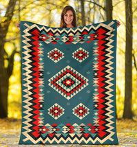 Multicolor geometric throw blanket with diamond motifs and zigzag border held outdoors