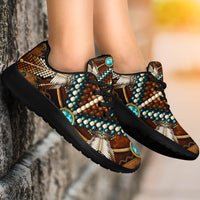 Brown multicolor sneakers on feet, turquoise heel badge, black laces and textured beadwork