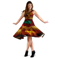 Twirl view of sleeveless 3D native-style dress in red, gold and green geometric print, wide hem