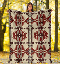 Cream blanket with repeating red and gray geometric stars and columns pattern