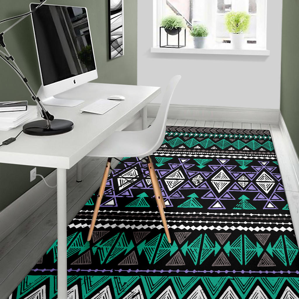 Neon tribal area rug with teal and purple triangle blocks and white zigzag stripes on black