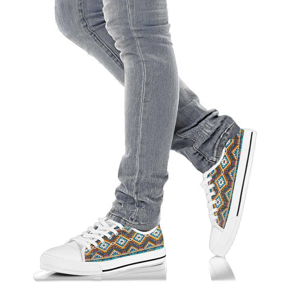 Shoes on feet: white low top sneakers with multicolor Aztec geometric side panel