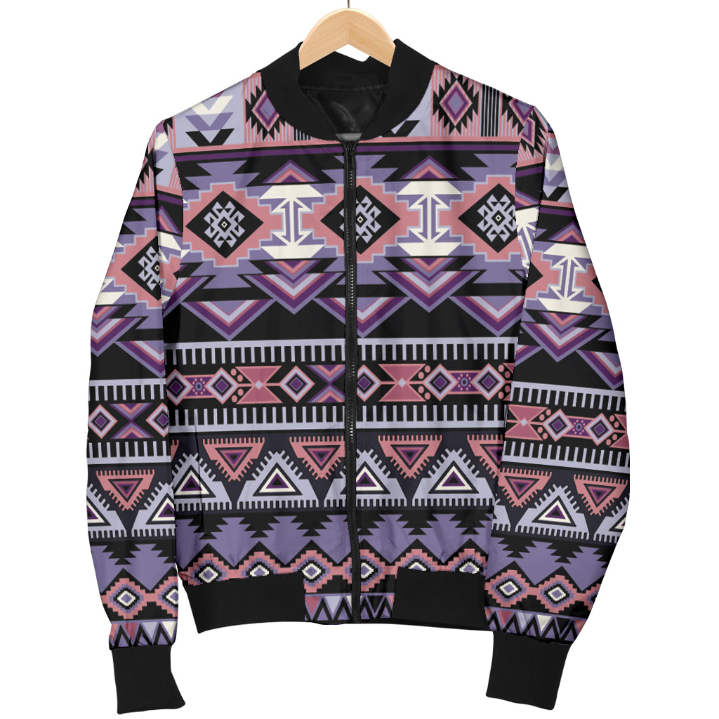 Women’s bomber jacket hanging on wooden hanger, black zip front, colorful geometric Aztec print