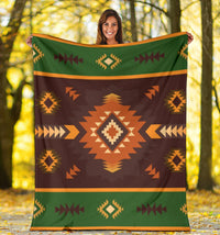 Geometric blanket outdoors showing dark brown field with green top stripe and orange diamond motif