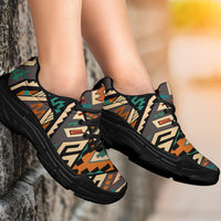 Chunky sneakers on feet, Native tribal geometric print upper with black laces and dark sole