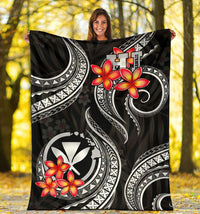 Black Polynesian blanket laid flat with red plumeria and white circular crest patterns