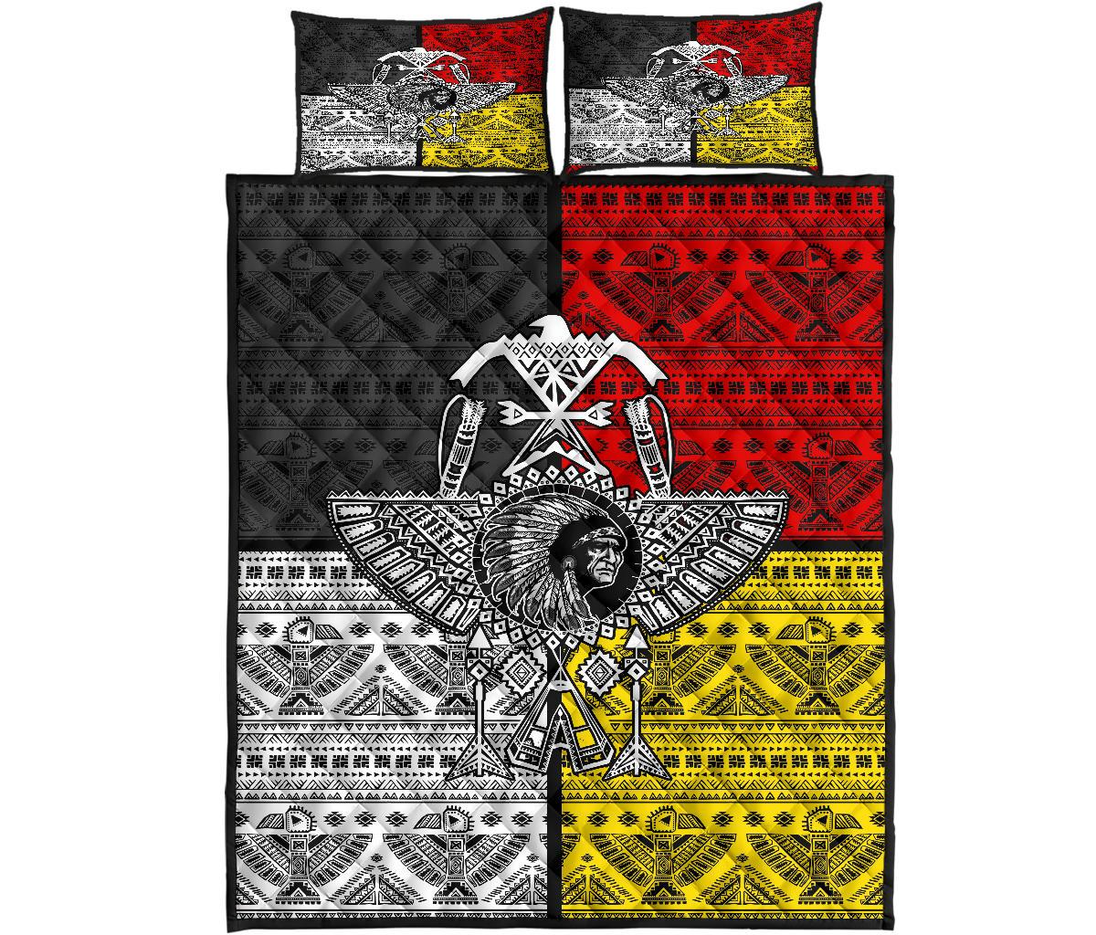 Front view quilt bed set with thunderbird emblem and banded tribal patterns in red, black, yellow