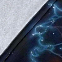 Close-up of galaxy wolf blanket fabric, dark print with blue starburst patterns