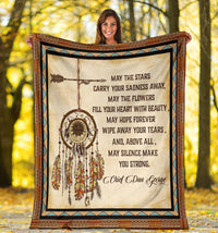 Native American style blanket held up, featuring dreamcatcher, feathers, and quote