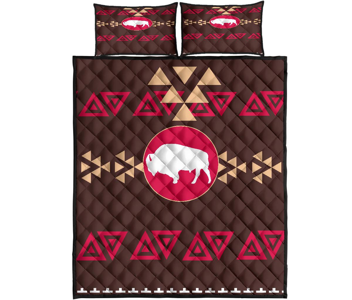 Quilt bed set: brown quilt with pink bison circle, red triangle motifs, two matching pillows