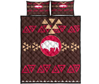 Quilt bed set: brown quilt with pink bison circle, red triangle motifs, two matching pillows