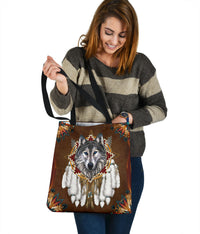 Brown tote bag with wolf portrait center, multicolor accents, and wide black shoulder strap
