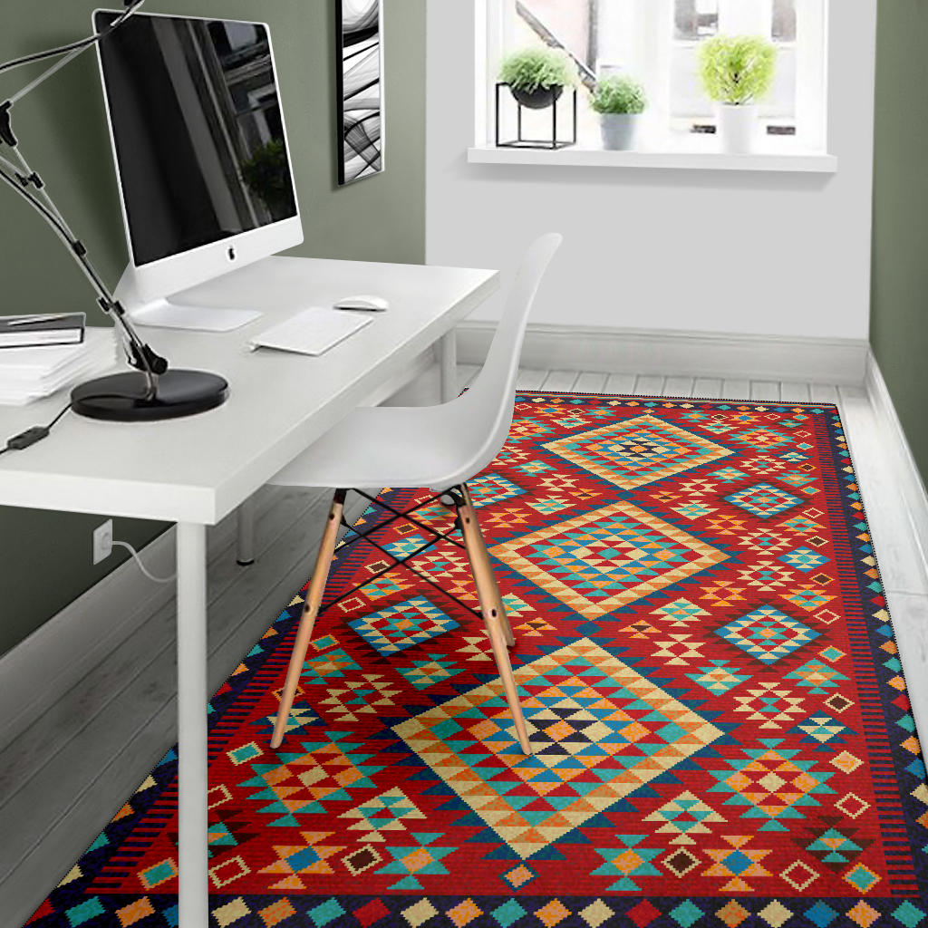 Rug with multicolor geometric pattern, red background, and dark navy edge trim