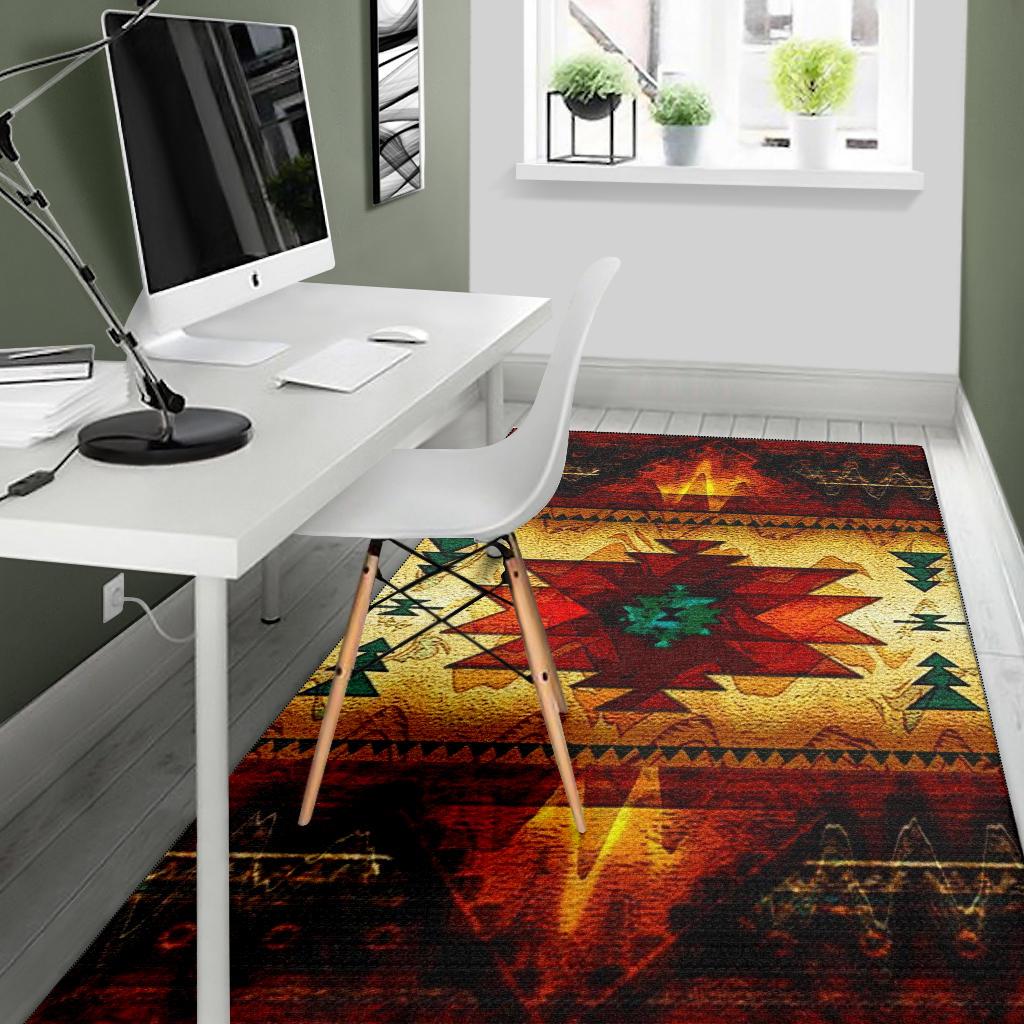 Tribal geometric area rug with red, yellow and green center design and dark perimeter