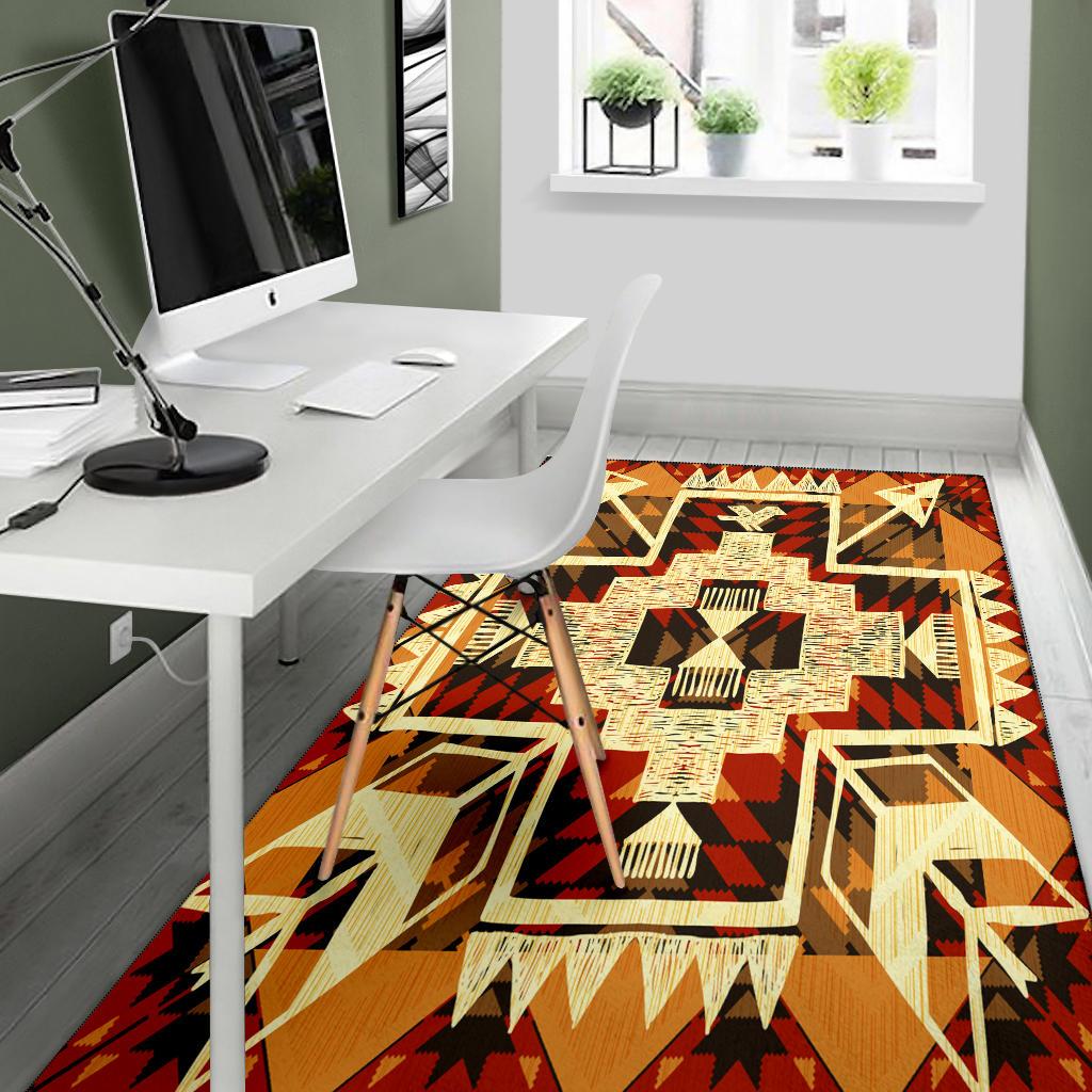 Tribal arrow rug with bold zigzag pattern; orange-brown base and cream, black, red shapes