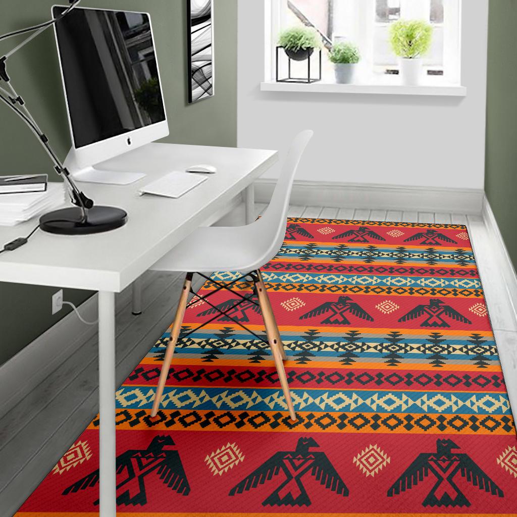 Red area rug featuring dark silhouette figures, diamond accents, and blue-orange stripes