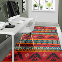 Red area rug featuring dark silhouette figures, diamond accents, and blue-orange stripes