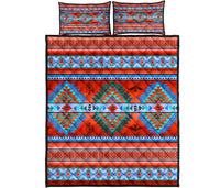 Red, turquoise, and blue quilt set with geometric bands and two matching pillow shams