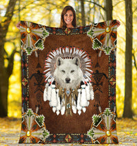 Brown square blanket with white wolf face, feather-spike headdress, and beaded corner motifs