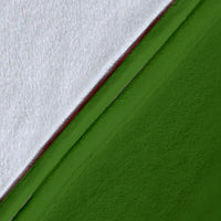 Green blanket fabric close-up with white edge, soft plush texture