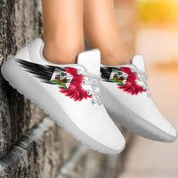 White sneakers with red-and-green flag wing graphic, lace-up, black sole