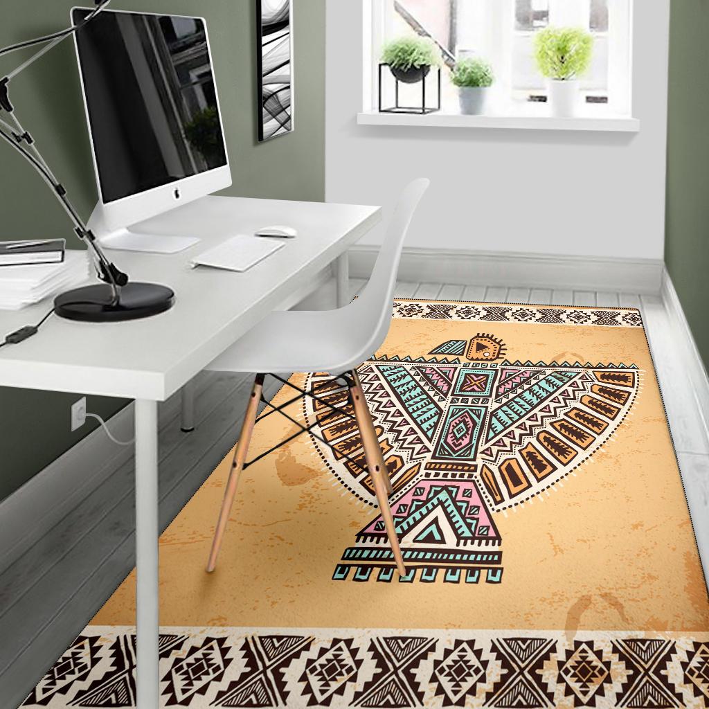 Beige Native-style geometric area rug with multicolor bird symbol and black patterned edge