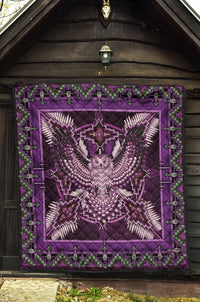 Purple Native American pattern quilt with beaded-looking center design and green stitched border