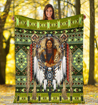 Green multicolor geometric chief blanket held up with central portrait artwork