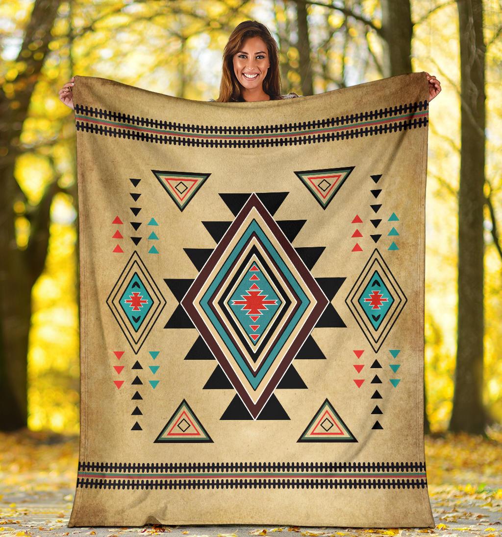 Tan Southwest symbol throw blanket with bold starburst center and red, teal, and black details