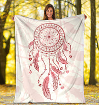 Pink dream catcher blanket spread outdoors with hoop, hearts, and dangling feather detail