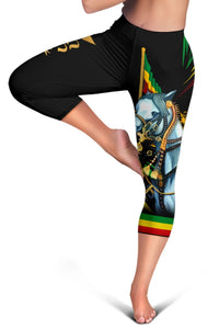 Black capri leggings close-up with blue horse portrait and green-yellow flag stripe