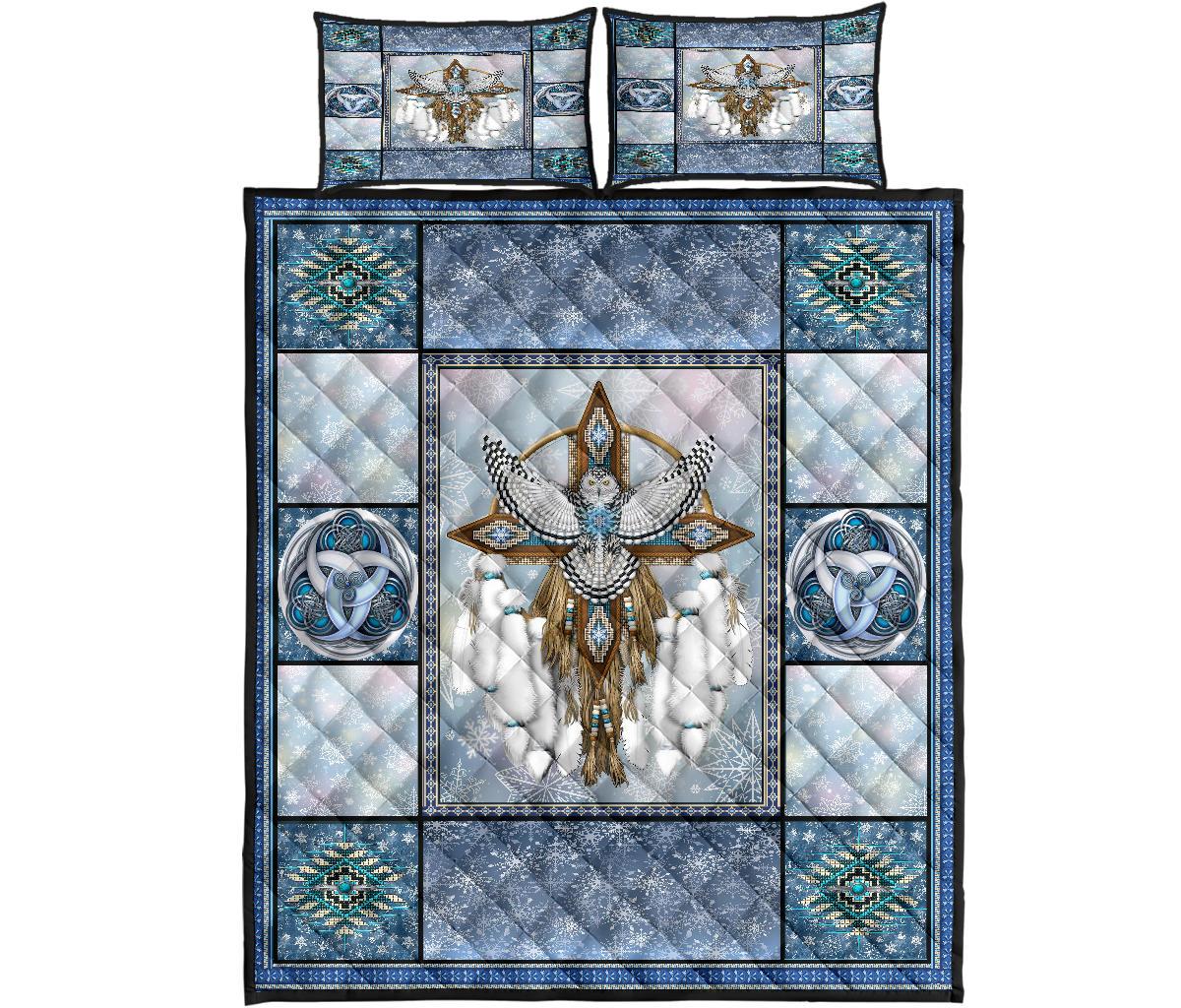 Studio view of dreamcatcher owl quilt bed set: blue border, teal motifs, two matching square shams