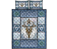 Studio view of dreamcatcher owl quilt bed set: blue border, teal motifs, two matching square shams