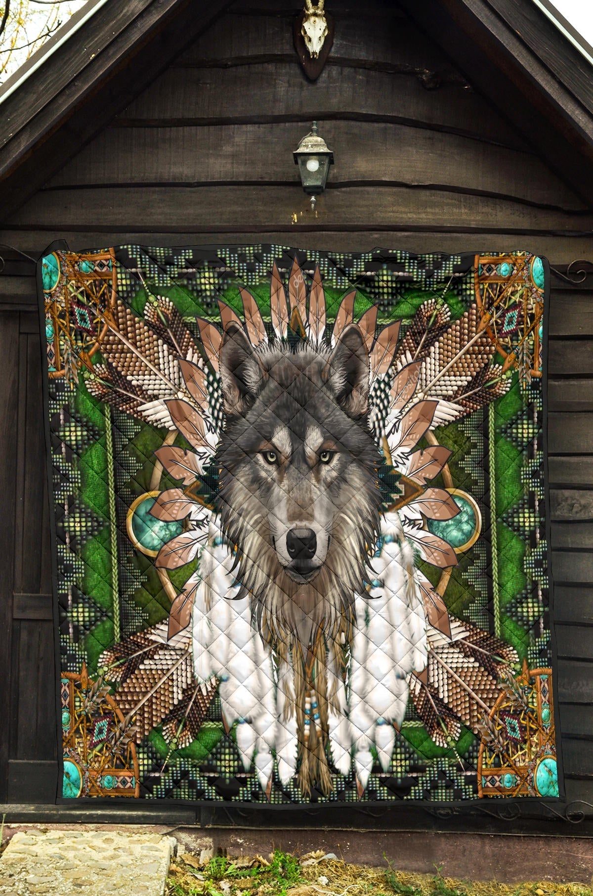 Wolf mandala quilt hanging on wall, green multicolor tribal wolf design with black trim