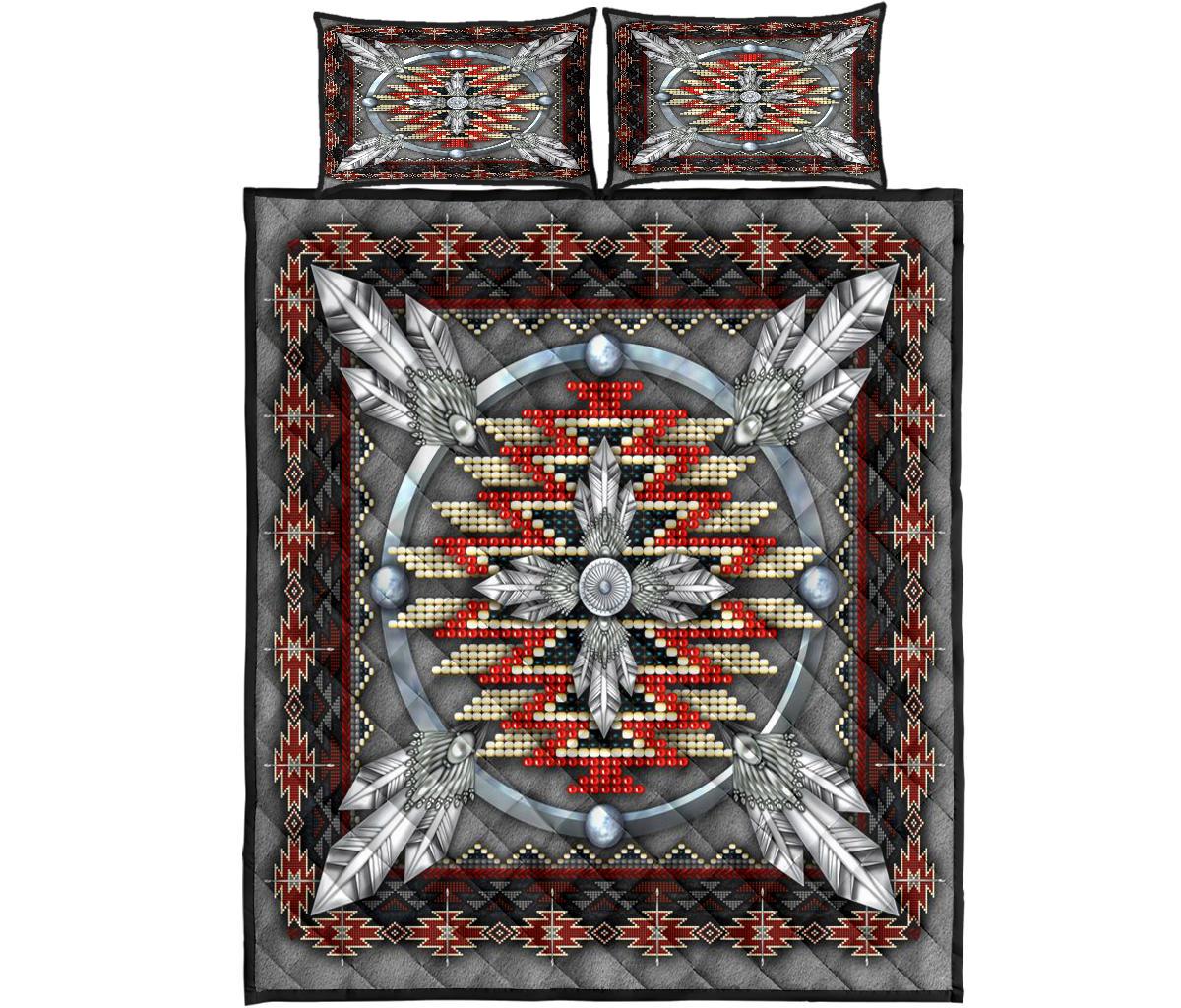 Top view of quilt bed set: gray quilt, red/cream bead circular centerpiece, black geometric border