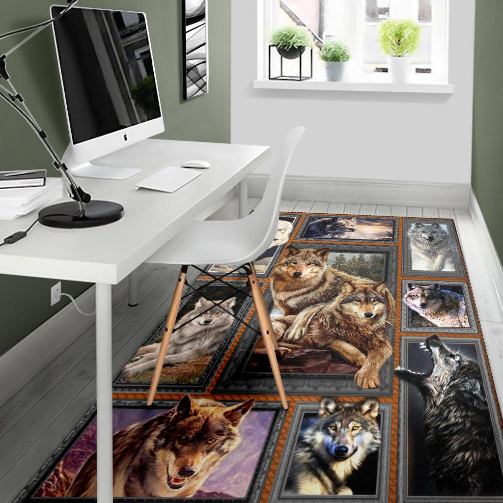 Multicolor wolf patchwork area rug with framed wolves, dark border, and central wolf panel