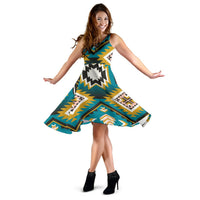 Turquoise sleeveless dress twirling, geometric Aztec-style print and flared hem